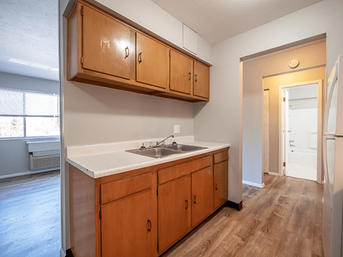A kitchen with wooden cabinets and a white countertop.