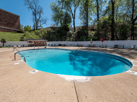 A small pool with a white fence around it.