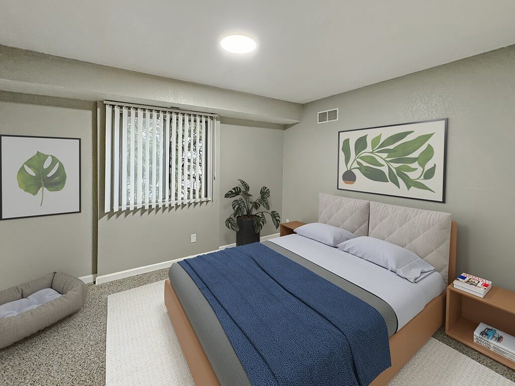 A bedroom with a large bed and a potted plant.