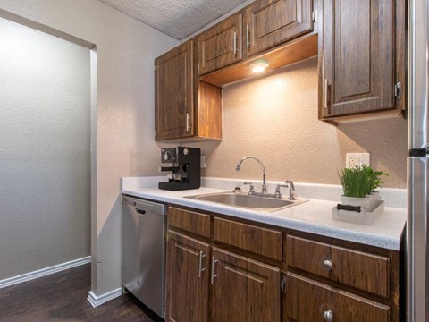 a kitchen with a sink and a refrigerator
