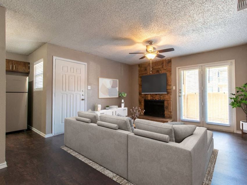 a living room with a couch and a tv in front of a fireplace - Photo Gallery