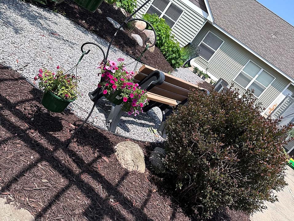 a chair sitting on top of a hill next to a potted plant