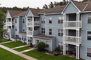 A large apartment complex with multiple balconies and patios.