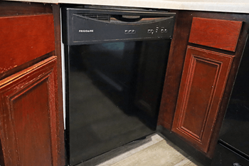 A black dishwasher in kitchen.