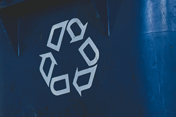 A blue recycling bin with a white recycling symbol on it.