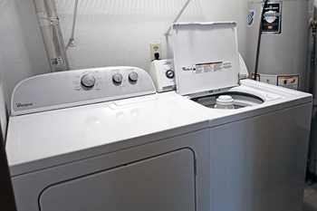A white washing machine and dryer in a small laundry room.
