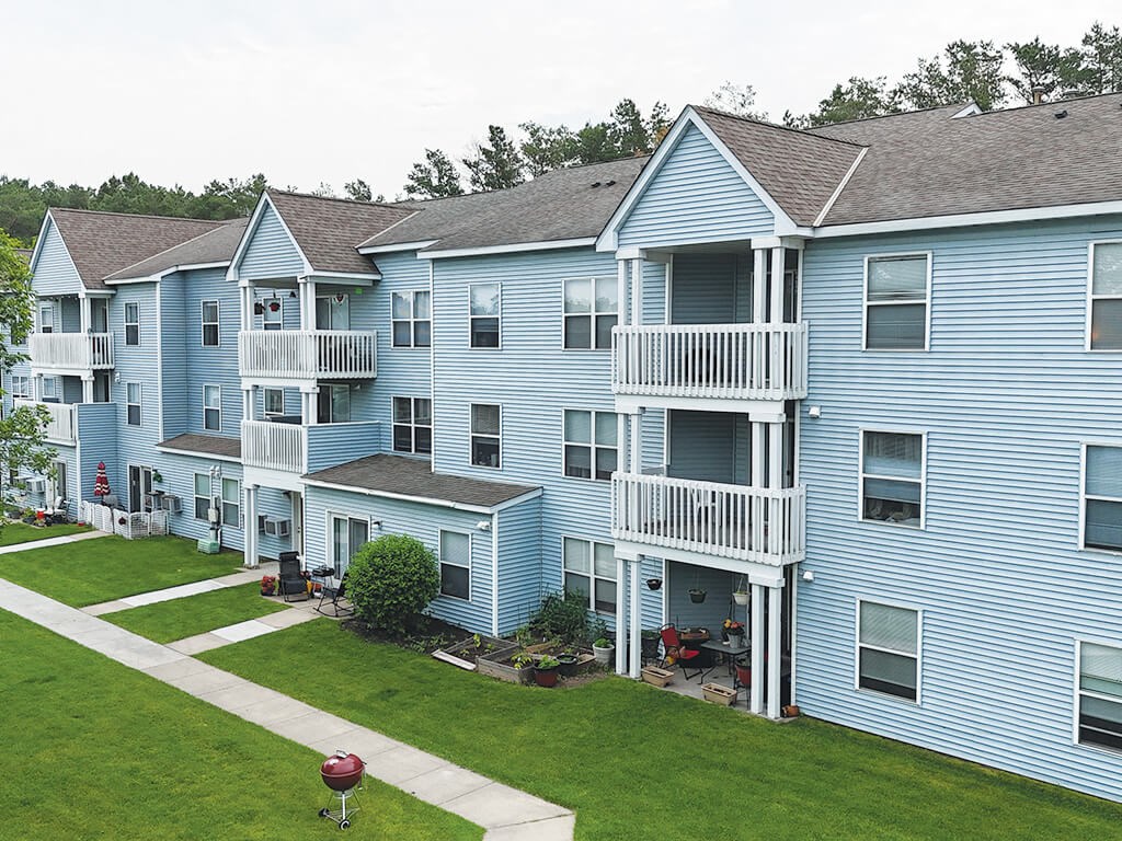 A blue building with a red object in front of it.