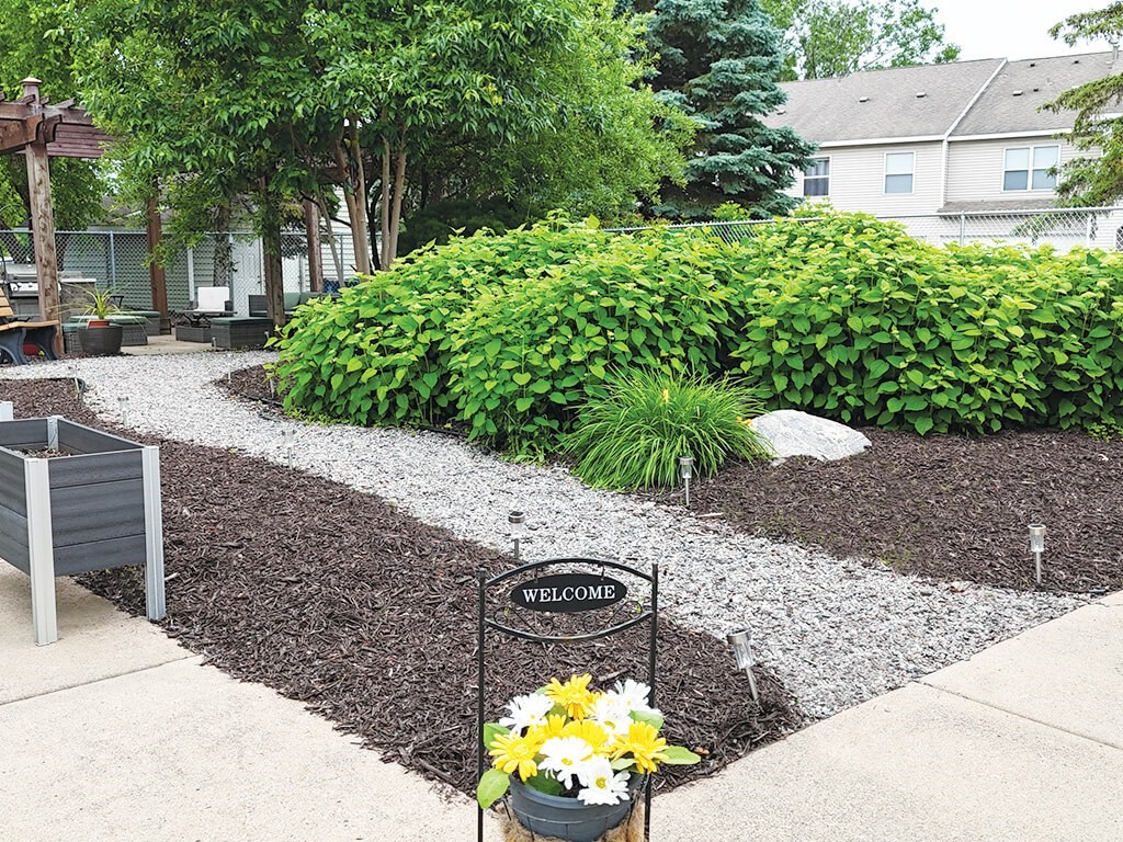 A garden with a sign that says