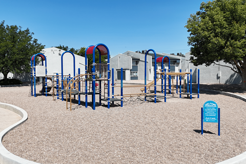 A playground with a blue sign that says