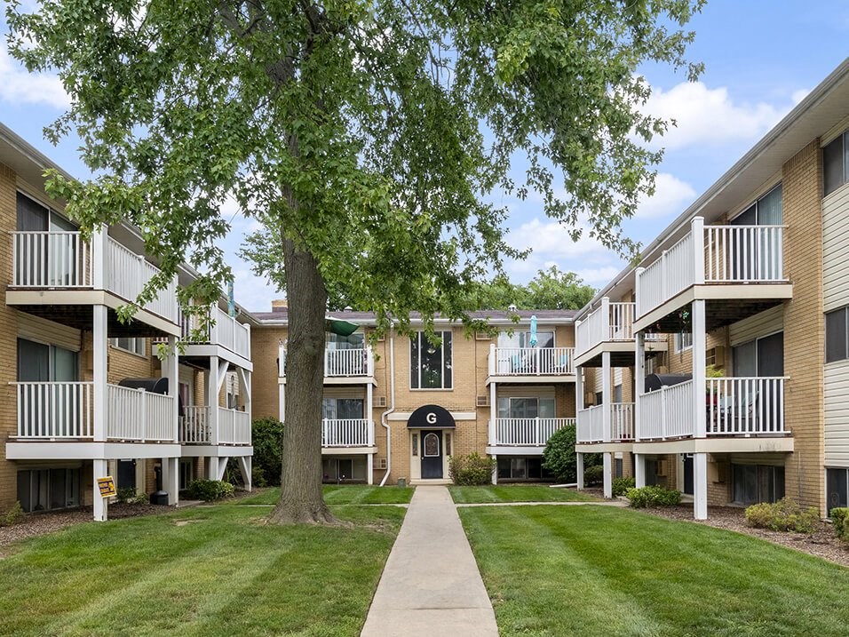our apartments have a spacious courtyard with green grass and trees