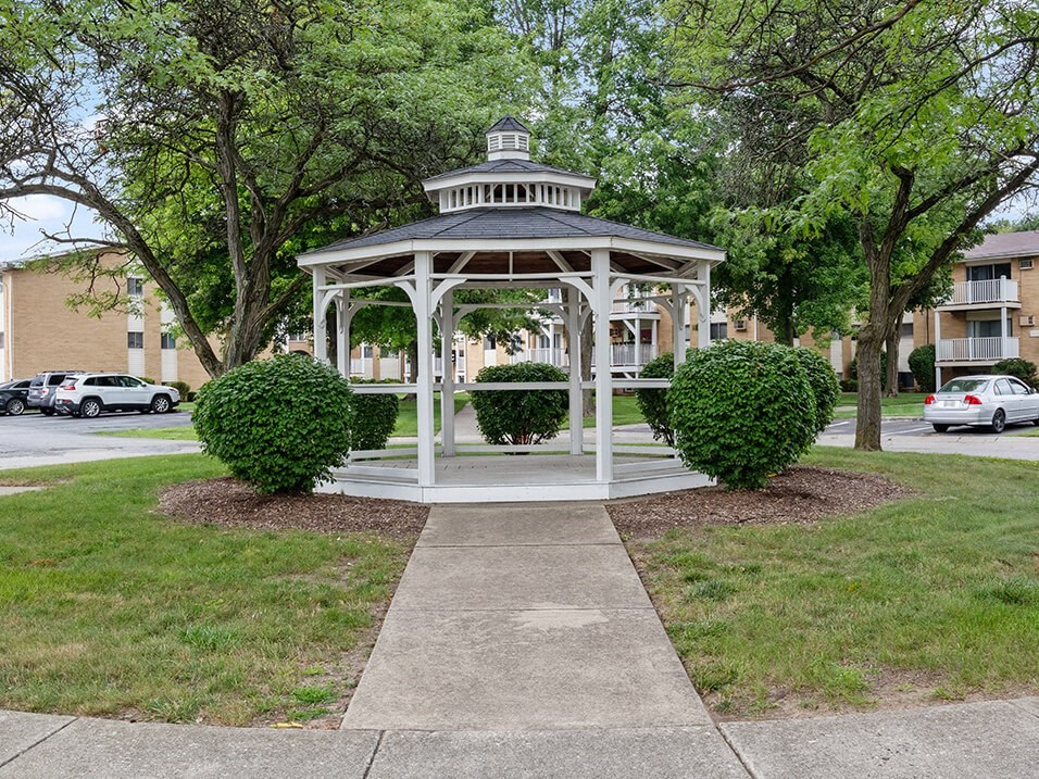 a white gazebo in the middle a community