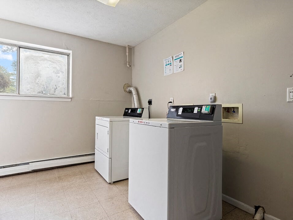 a laundry room with a washer and dryer and a window