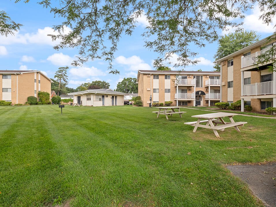 our apartments are located in a grassy area with picnic tables