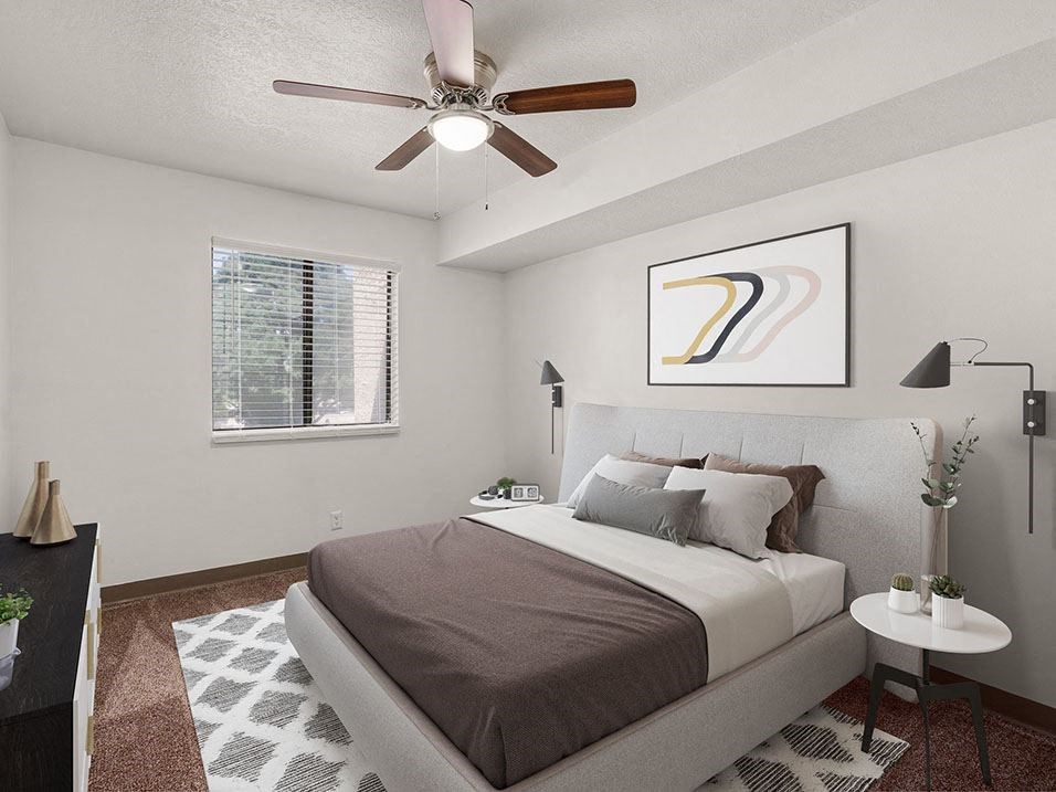 a bedroom with a ceiling fan and a window