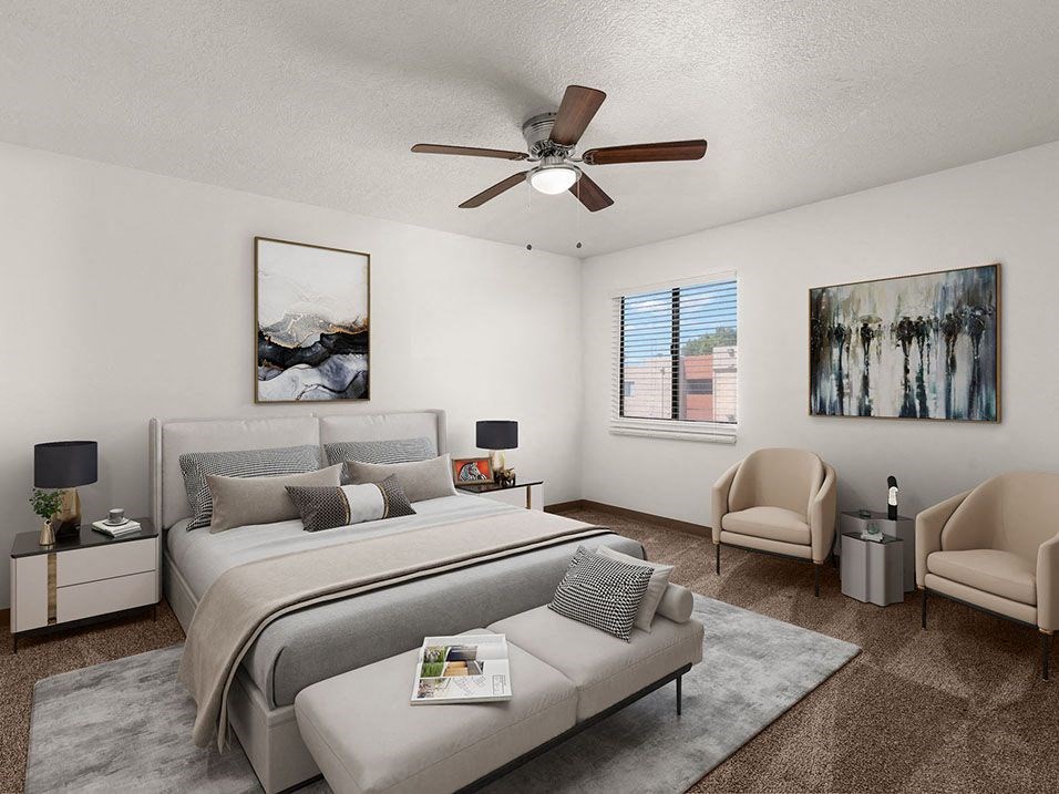 a bedroom with a large bed and a ceiling fan