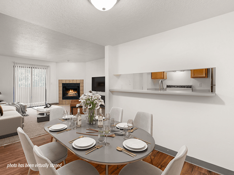 A dining room with a table set for a meal.