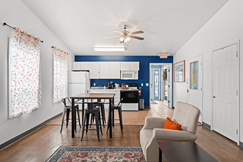 A dining room with a table and chairs.