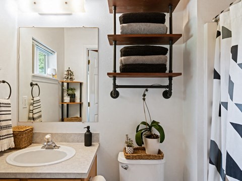 full bathroom with under the sink storage at mountaineer village apartments