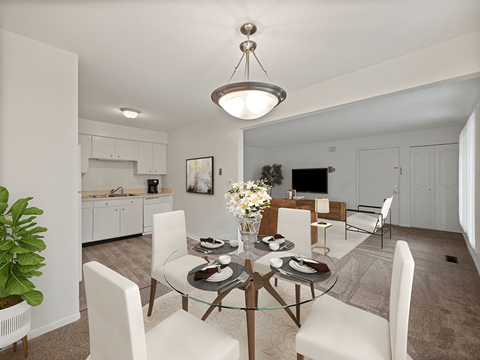 A modern dining room with a glass table and white chairs.