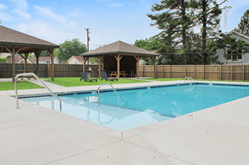 A small pool with a pavement around it.