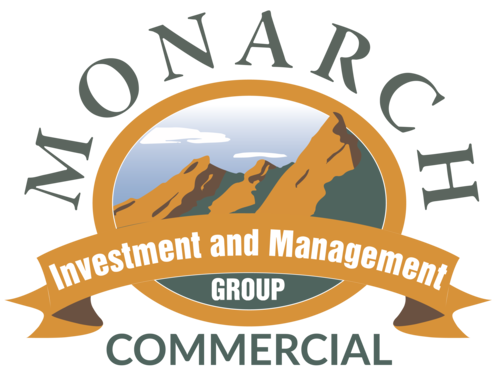 a logo for the ocean investment and management group with mountains
