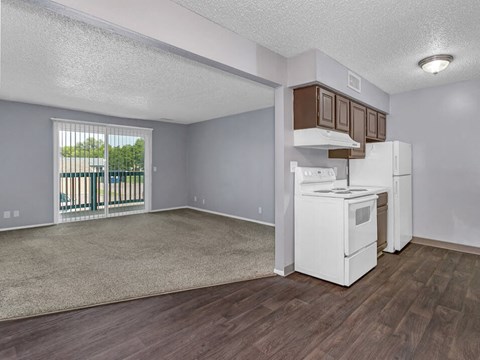 A kitchen area with a white fridge and stove top oven.