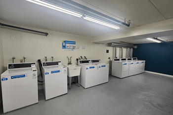 A laundromat with several washing machines.