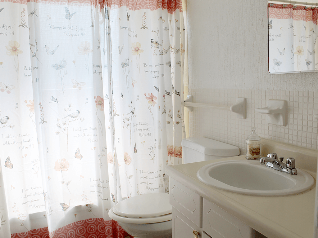 a bathroom with a sink, toilet, and shower tub