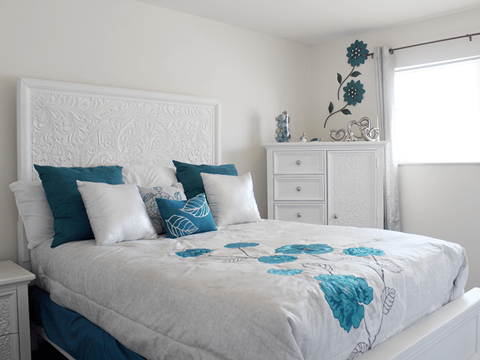 apartment bedroom with a white bed