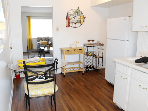 a small kitchen and dining room with a table and chairs
