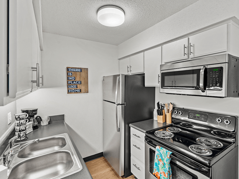 our modern kitchen has stainless steel appliances and a stainless steel sink