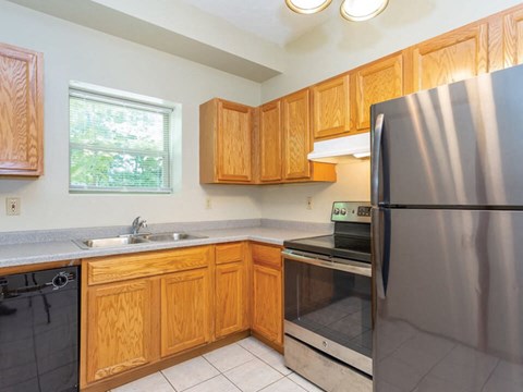 a kitchen with stainless steel appliances and wooden cabinets
