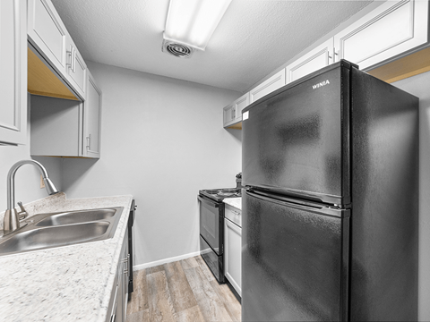 the kitchen of our studio apartment atrium with stainless steel appliances and white cabinets