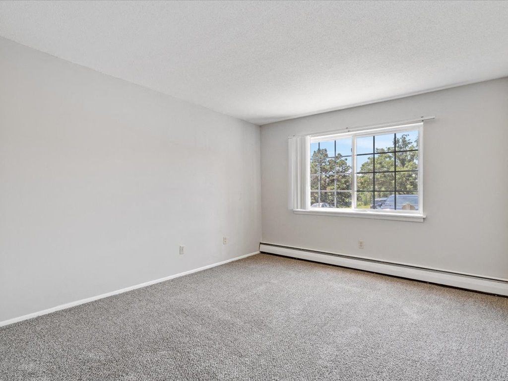 bedroom with a window and blinds