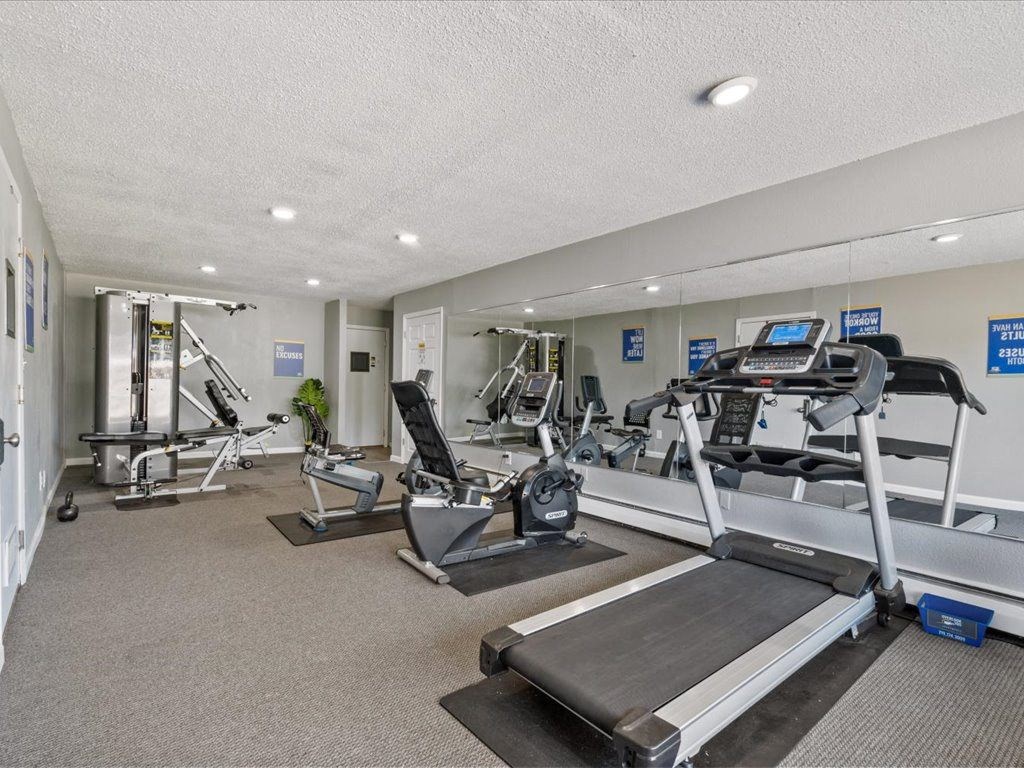a gym with treadmills and other exercise equipment