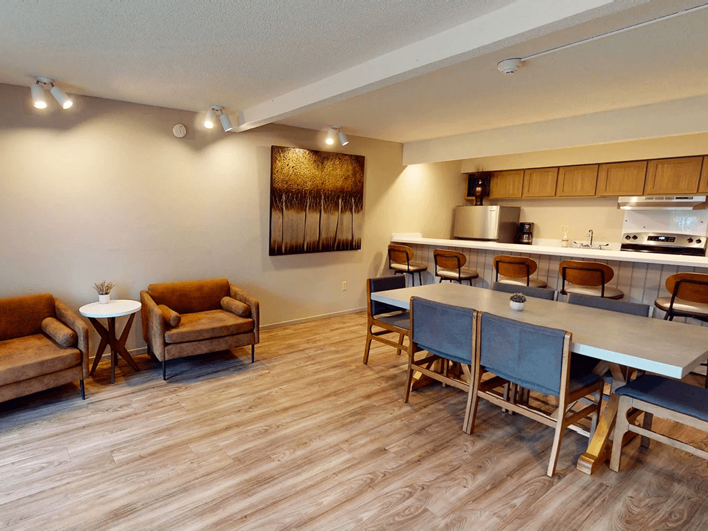 A dining area with a table and chairs.