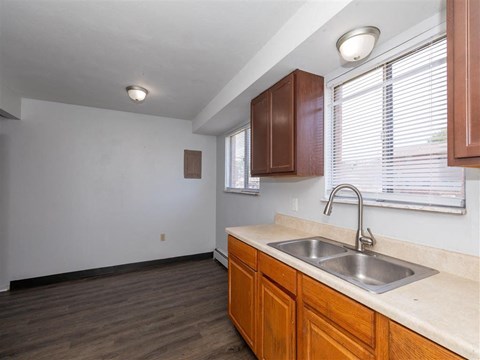 A kitchen with wooden cabinets and a white countertop.