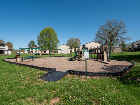 A playground with a swing set and a slide.