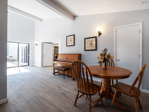 A dining room with a table and chairs.