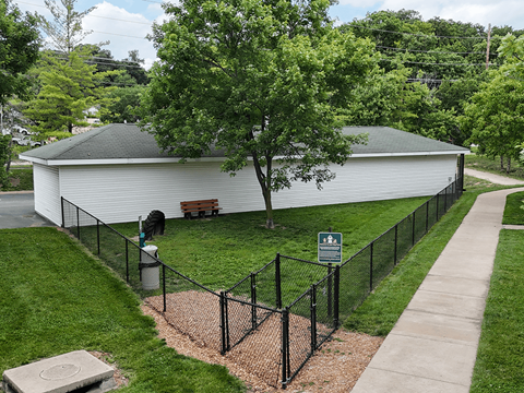 A white building with a black fence in front of it.
