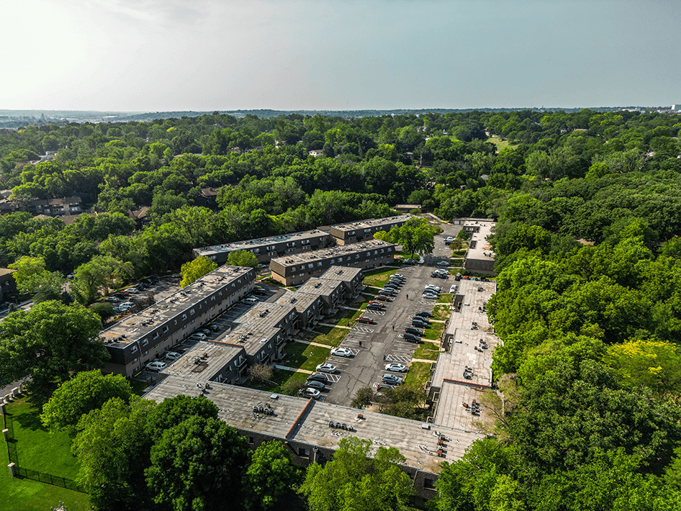 an aerial view of an abandoned building surrounded by trees