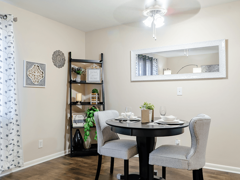 a dining room with a table and chairs