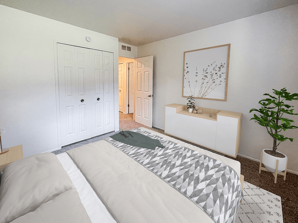 a bedroom with a bed and a plant and a closet