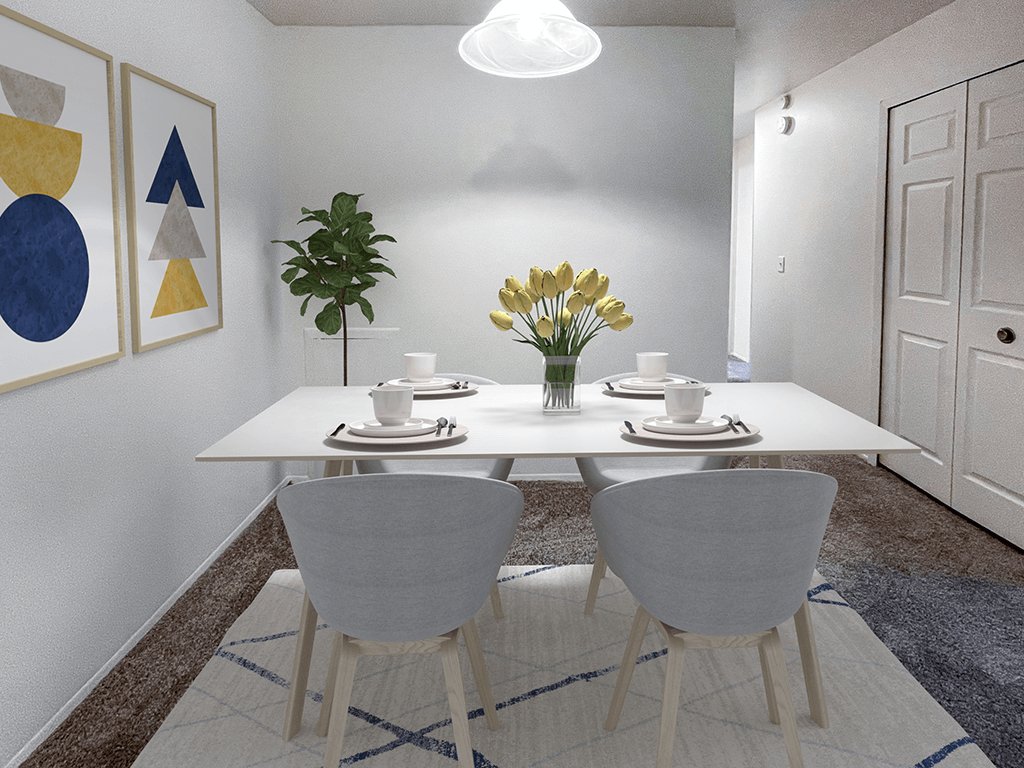 a dining room with a white table and chairs