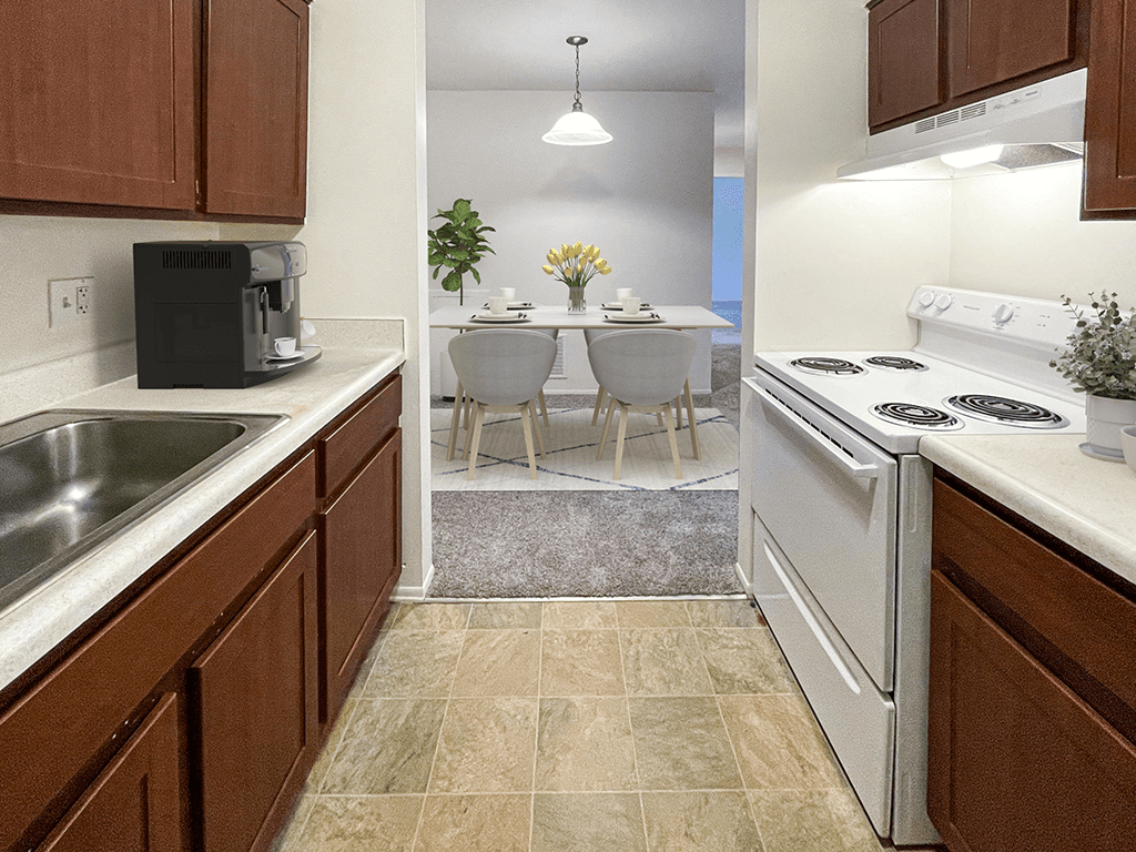 a kitchen with white appliances and a dining room with a table