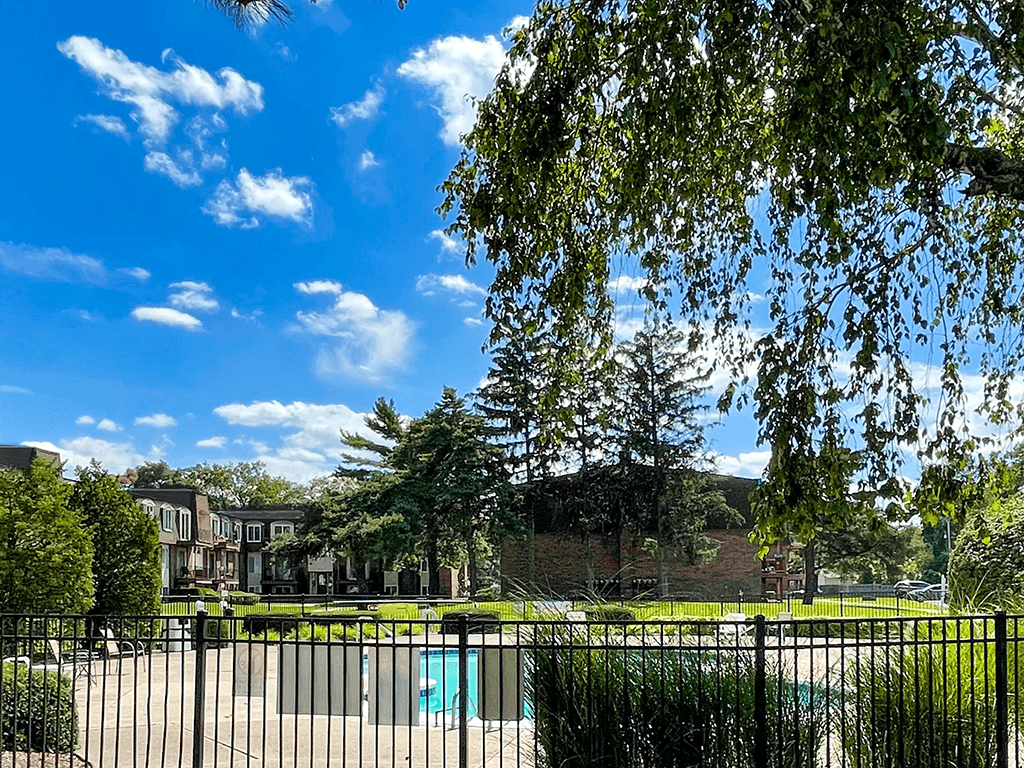 a view of a park with a pool behind a fence
