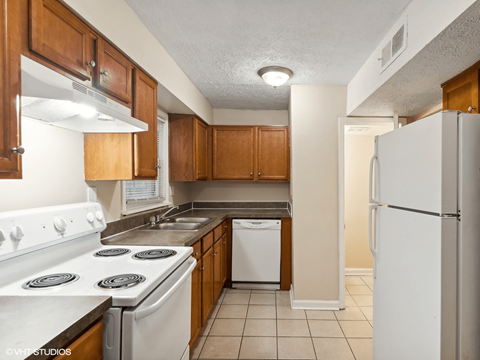 a kitchen with white appliances and wooden cabinets