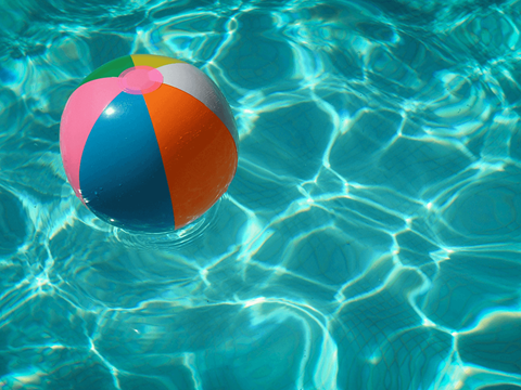 a colorful beach ball floating in a pool