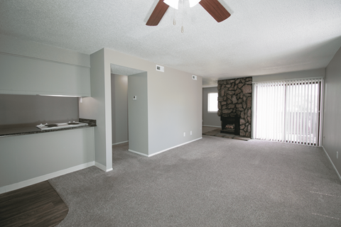 A dining area and living room at Ponderosa Apartments in Wichita, KS