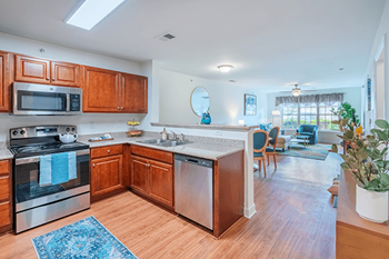 A kitchen with wooden cabinets and a stove top oven.